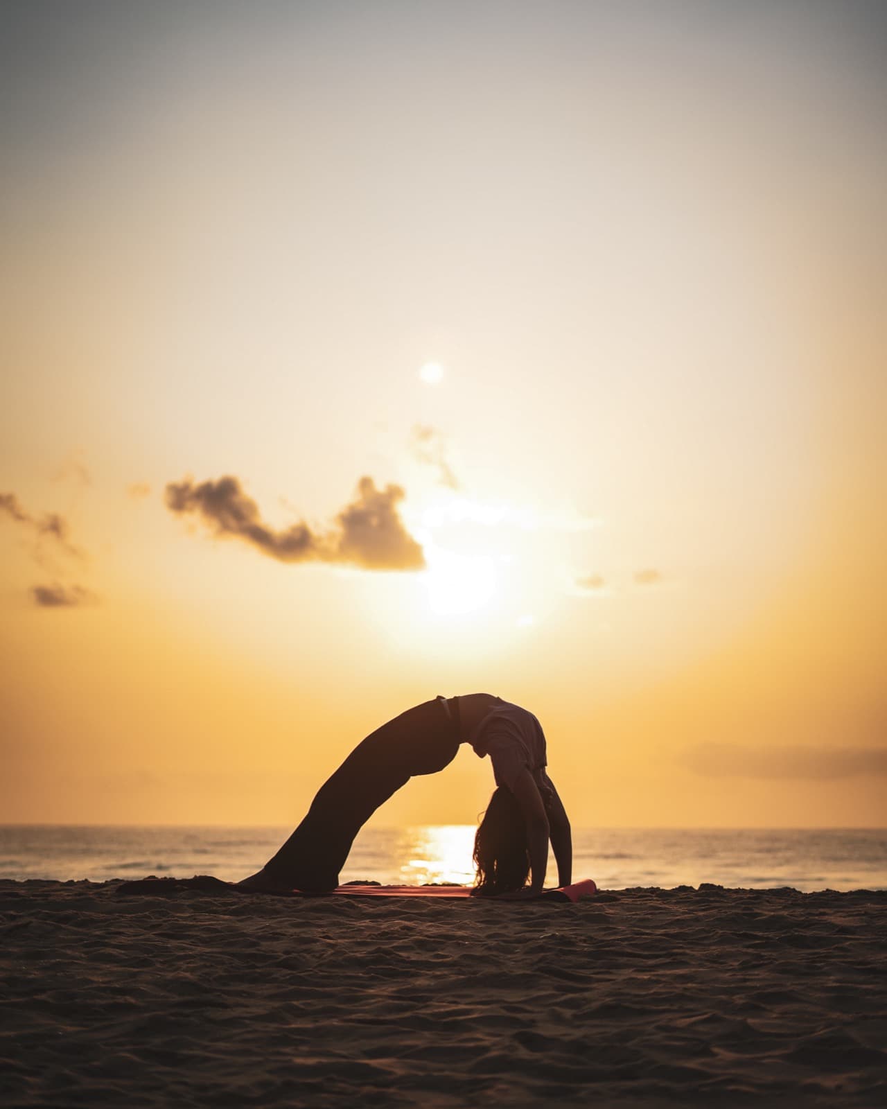 Ashwitha in wheel pose at golden hour